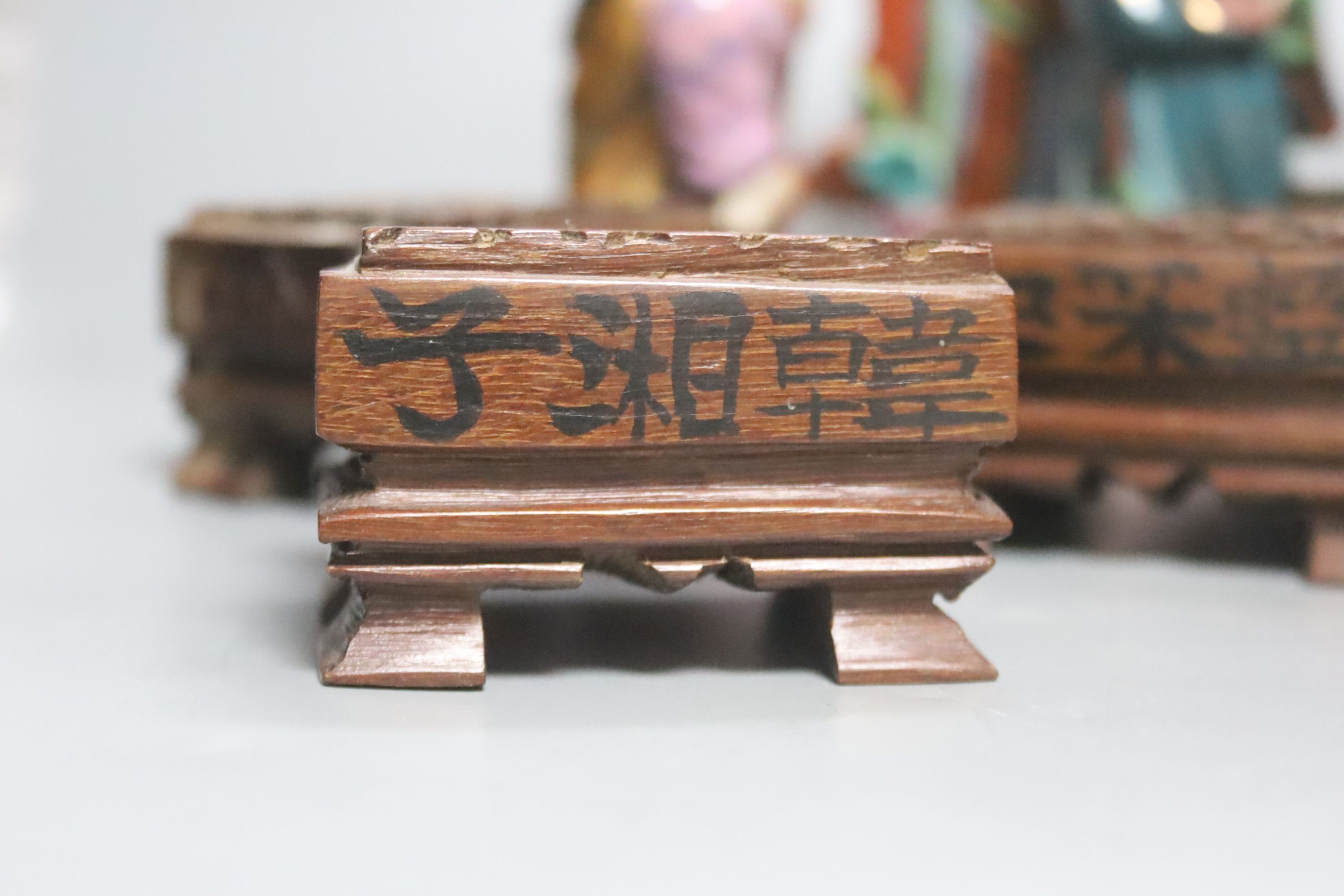 A set of eight 20th century Chinese porcelain figures of immortals, 15cm, each on carved wood stand